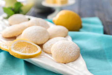 Plate with homemade lemon cookies on table, closeup