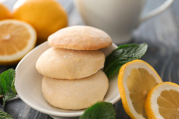 Plate with homemade lemon cookies on table, closeup
