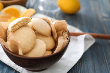 Bowl with homemade lemon cookies on wooden table