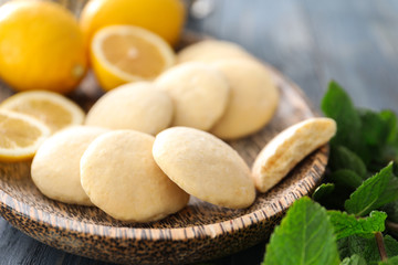 Plate with homemade lemon cookies on table, closeup