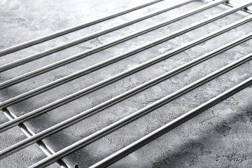 Metal baking grid on grunge table, closeup