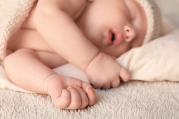 Cute little baby sleeping on bed at home