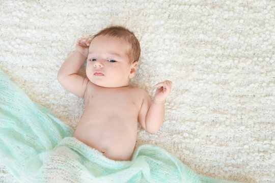 Cute little baby lying on soft plaid