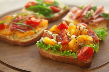 Fototapeta na wymiar Tasty sandwiches on wooden board, closeup