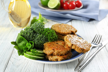 Broccoli pancakes served with lime slices on plate