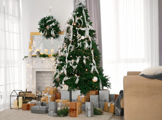 Beautiful fir tree in decorated room for Christmas