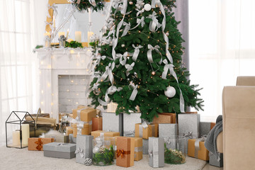 Beautiful fir tree in decorated room for Christmas