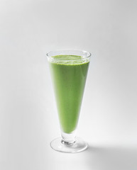 Glass of fresh green smoothie on white background