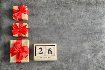 Calendar with date and gift boxes on grey background. Christmas concept
