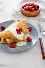 Pancakes with raspberries and cream.