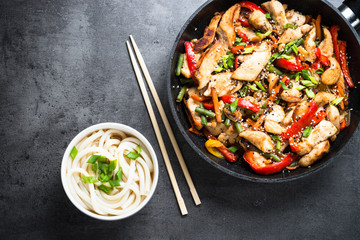 Chicken Stir fry and udon noodles on black.