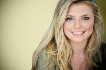 Composite image of close up portrait of smiling young blonde