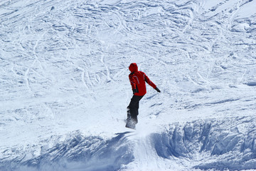 Skiers and snowboarders riding on a ski slope in Sochi mountain resort snowy winter