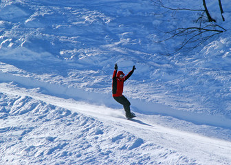 Skiers and snowboarders riding on a ski slope in Sochi mountain resort snowy winter