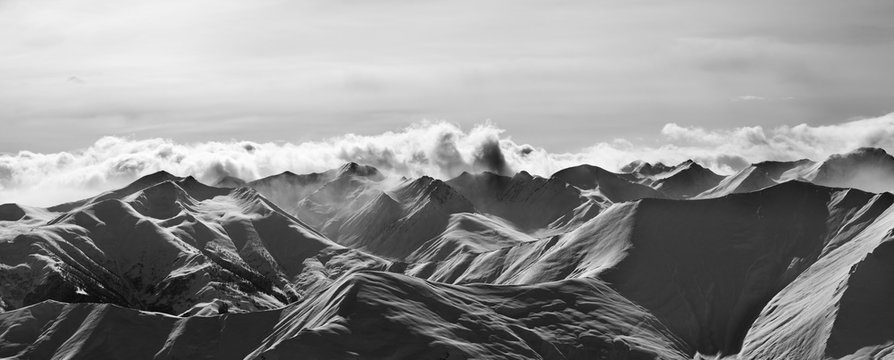 Fototapeta Black and white panorama of evening snow mountains