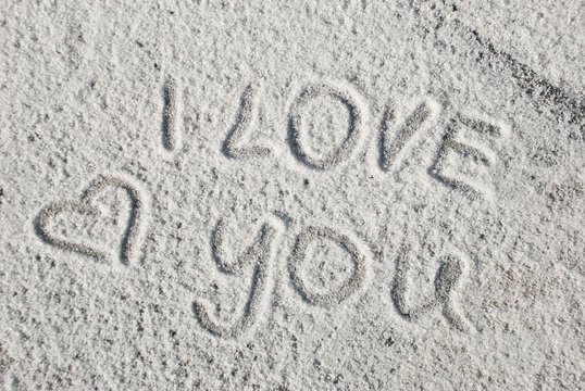 Handwriting text I love You on salt. Symbol of love. Valentine day card. Romantic background.