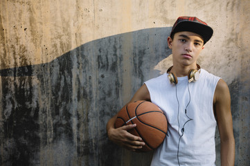 Naklejka premium Young Man Holding a Basketball Ball