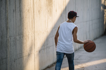Fototapeta premium Young Man Holding a Basketball Ball