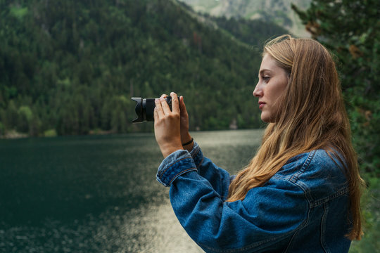 Woman taking shots on mountain lake