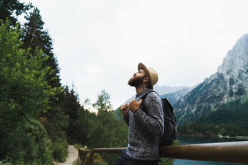 Handsome tourist at mountain lake