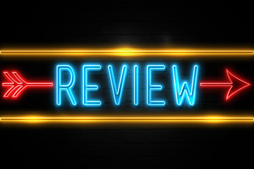 Review  - fluorescent Neon Sign on brickwall Front view