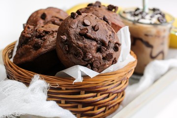 Homemade Banana chocolate chip muffins served in a basket, selective focus