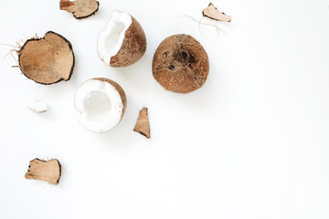 Fototapeta na wymiar Cracked coconut on white background. Flat lat, top view