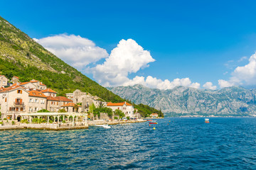 Fototapeta na wymiar MONTENEGRO - JUNE 04/2017. Tourists sailed on the yacht past the city of Perast in the Boka Bay of Kotor.