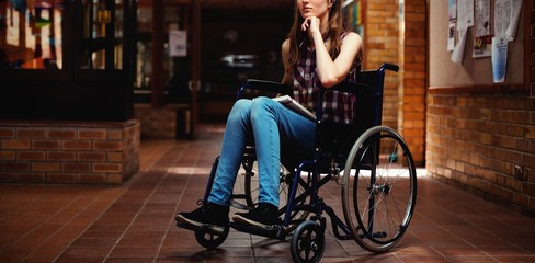 Disabled schoolgirl on wheelchair in corridor at school - Powered by Adobe