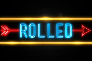 Rolled  - fluorescent Neon Sign on brickwall Front view