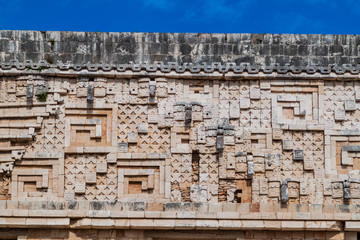 Detil of the stonework at the Palacio del Gobernador (Governor's Palace) building in the ruins of the ancient Mayan city Uxmal, Mexico