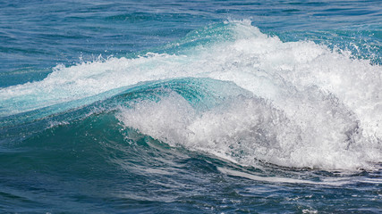 Beautiful blue ocean waves creates powerful splashes