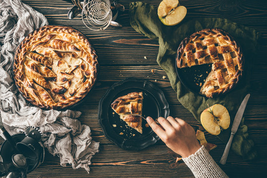 American apple pies on dark wooden table, top view