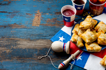 Chilean independence day concept. fiestas patrias. Chilean typical dish and drink on independence day party, 18 september. Mini empanadas, mote con huesillo, wine with toasted flour, chicha and