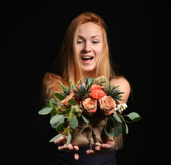 Beautiful red hair woman with vintage rustic bouquet of wild roses Carnation flowers