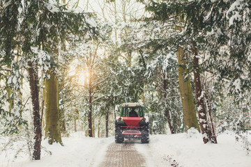 A shovel clearing the road of snow in the woods