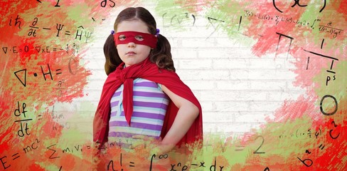 Composite image of portrait of girl standing in superhero