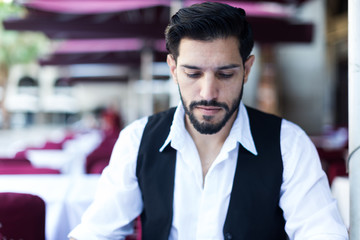 Young man resting on summer terrace cafe