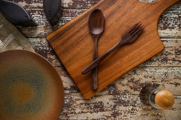 pile of kitchen utensils on wooden background.
