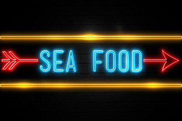 Sea Food  - fluorescent Neon Sign on brickwall Front view