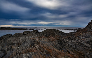 Darkly shore of the Barents Sea. Cape Kekursky. Kola Peninsula, Russia.