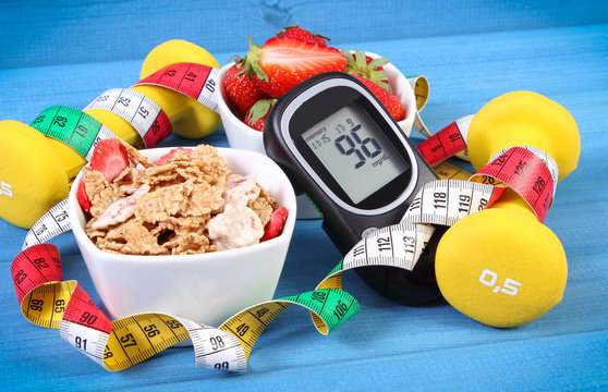 Glucometer with sugar level, healthy food, dumbbells and centimeter