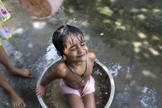 A kid enjoy bathing