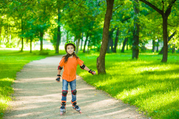 Girl learn to roller skate in summer park. Space for text.