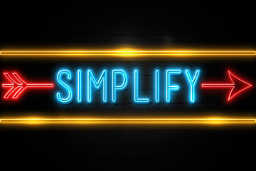 Obraz premium Simplify - fluorescent Neon Sign on brickwall Front view