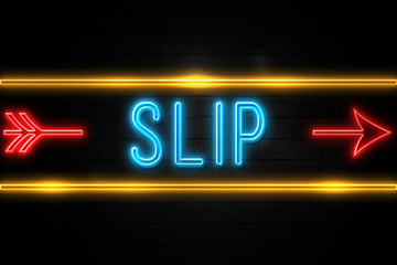 Slip  - fluorescent Neon Sign on brickwall Front view