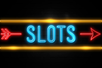 Slots  - fluorescent Neon Sign on brickwall Front view