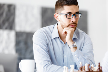 Portrait of two young man playing chess 