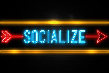 Socialize  - fluorescent Neon Sign on brickwall Front view