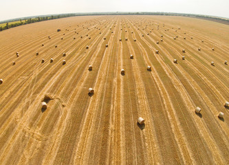 View from a bird's eye view on a field with stacked bales of wheat